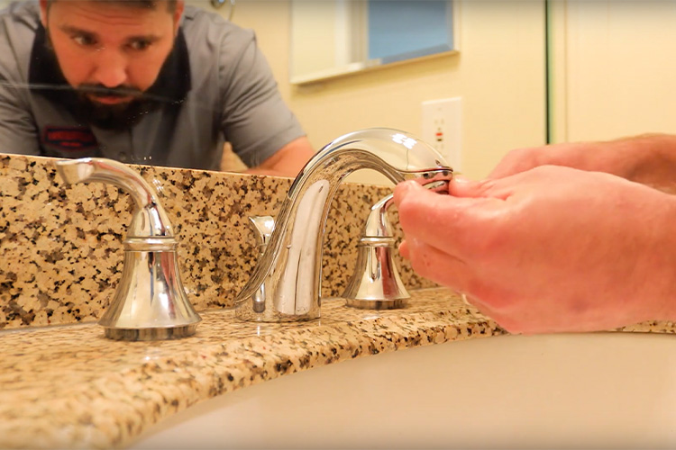 Plumb Works Academy instructor demonstrating how to clean a faucet aerator.